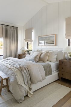 a bedroom with white walls and wooden floors