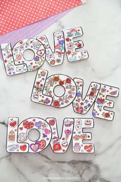 two magnets with the words love and hearts on them sitting next to each other