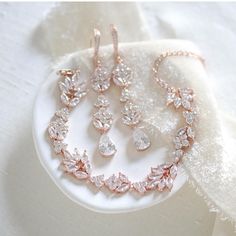 Add the perfect amount of sparkle to your bridal look this delicate and feminine rose gold jewelry set!  - Crafted with Premium cubic zirconia stones . - All clear stones - Available in rhodium, yellow gold or rose gold finish - Earrings measure 1.75 inches x  0.375 inch - Bracelet measures 6 inches and extends to 8 inches - Nickel free and hypoallergenic - READY TO SHIP IN ROSE GOLD This is an original design by © Treasures by Agnes Feel free to contact me with any questions ! Browse our earrin Rose Gold Crystal Jewelry For Wedding, Rose Gold Elegant Jewelry With Cubic Zirconia, Rose Gold Cubic Zirconia Jewelry With Elegant Design, Rose Gold Cubic Zirconia Jewelry For Wedding, Hand Set Rose Gold Jewelry Sets For Wedding, Dainty Rose Gold Crystal Jewelry, Rose Gold Wedding Jewelry With Sparkling Stones, Dainty Rose Gold Jewelry With Sparkling Stones, Dainty Rose Gold Wedding Jewelry