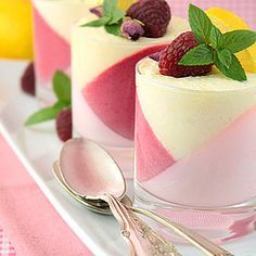 three desserts on a plate with spoons and utensils next to each other