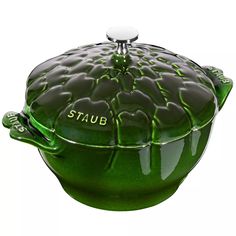 a green casserole dish with the word stuub on it's lid