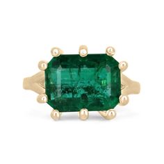 an emerald ring set in yellow gold