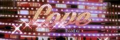 the word elvis written in neon lights on a background with many different colors and shapes