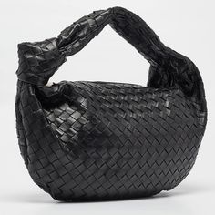 BOTTEGA VENETA Black Intrecciato Leather Small Jodie Hobo  This Bottega Veneta Jodie bag is crafted from leather using their signature Intrecciato weaving technique into a seamless silhouette. This bag, personifying elegance and subtle charm, is held by a knotted handle. The bag has an interior sized to hold your days essentials.   Size: Height: 28 cm, Width: 7 cm, Length: 48 cm  Material: Leather  This item has been used and may have some minor flaws. Before purchasing, please refer to the images for the exact condition of the item.   A return request must be submitted within 48 hours after delivery. Customer is responsible for return shipping costs and fees. Estimated return shipping costs for this item are $80. Contact Our Customer Support for details.  This item ships internationally a Small Jodie, Jodie Bag, Bottega Veneta Jodie, Dior Shoulder Bag, Celine Shoulder Bag, Small Shoulder Bags, Prada Shoulder Bag, Gucci Shoulder Bag, Vintage London