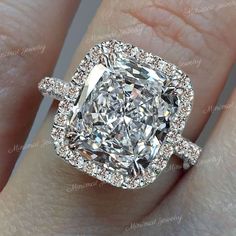 a cushion cut diamond with halos on the shoulders