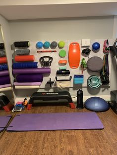 there are many yoga mats and exercise equipment on the wall