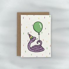 a birthday card with a purple snake holding a green balloon on it's head