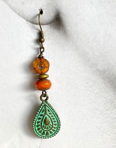 Czech Bead Dangle Earrings, Brass patina Mandela charm, golden flower bead and a pumpkin colored rondelle bead make up these gorgeous earrings. Bohemian Earrings With Spacer Beads As Gift, Bohemian Earrings With Spacer Beads For Gift, Bohemian Teardrop Earrings With Spacer Beads, Bronze Dangle Beaded Earrings For Jewelry Making, Vintage Dangle Jewelry With Colorful Beads, Eclectic Beaded Gold Jewelry, Eclectic Gold Jewelry With Round Beads, Eclectic Gold Beaded Jewelry, Vintage Gold Earrings With Colorful Beads