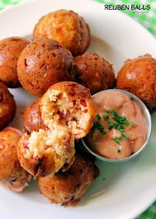 a white plate topped with meatballs and dipping sauce