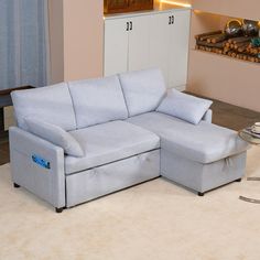 a living room with a couch and ottoman