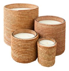 three wicker baskets with candles in them