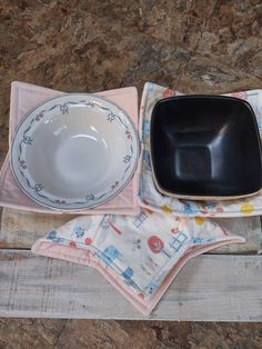 an empty bowl, plate and napkin on a wooden table