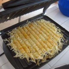 an image of food being cooked on a griddle in the kitchen or dining room