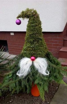 a christmas decoration made out of plants and balls