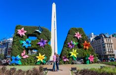 a man standing in front of the letters made out of flowers