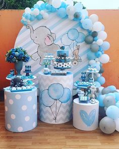 an elephant themed birthday party with balloons and decorations on the table, including blue and white decor