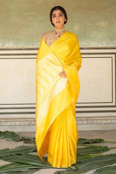 Yellow mashru silk saree with vintage gold zari kadua technique woven border in paisley pattern. Comes with running blouse piece.
Components: 1
Pattern: Woven
Type Of Work: Paisley Pattern
Fabric: Silk Mashru
Color: Yellow
Other Details: 
Note: The stitched blouse worn by the model is not for sale
Disclaimer: The joint fabric pieces may vary. Designers unique process ensures that the placement of fabric will always be similar but not same. They always create the product with stretch fabrics of s Yellow Banarasi Silk Blouse Piece For Season Transition, Transitional Yellow Banarasi Silk Blouse Piece, Yellow Silk Blouse Piece With Zari Weaving, Yellow Silk Pre-draped Saree With Self Design, Gold Anarkali Style Cotton Silk Pre-draped Saree, Gold Silk Pre-draped Saree For Navratri, Transitional Pre-draped Gold Silk Saree, Gold Silk Blouse Piece For Puja, Yellow Cotton Silk Blouse Piece For Wedding