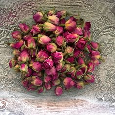 a bunch of pink flowers sitting on top of a table