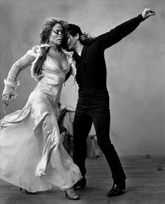 a man and woman are dancing on the dancefloor in black and white photo