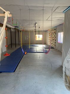 an empty gym with hammocks and swings