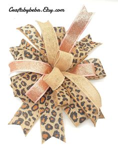 a leopard print bow with gold glitter ribbon