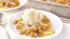 a white plate topped with a scoop of ice cream next to a pan of food