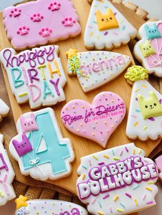 decorated birthday cookies on a wooden board with the words happy birthday written in large letters