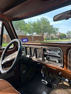 the interior of an old car with wood trim and dash board, steering wheel and dashboard controls