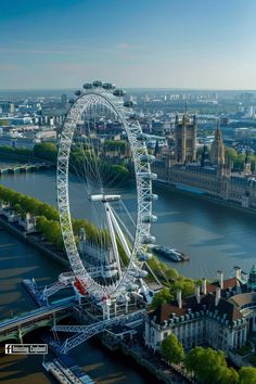 an aerial view of the london eye in england, with other buildings and water surrounding it