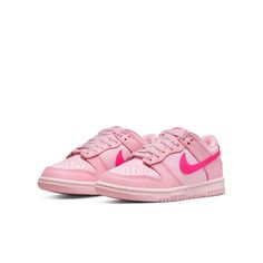 The Nike Dunk Low GS 'Triple Pink' is the ultimate representation of eye-catching style. The shoe offers full leather construction, which is brought to life with three distinct peppery shades of pink. The lightest shade provides the foundation for this cheerful design, with a slightly darker overlaying hue adding depth and detail. To make a bold statement, Nike branding swoops in with a vibrant pink Swoosh across both sides of the low-profile silhouette, complemented by further branding on sole, heel, tongue and inner sole. Grade School (GS) sizing adds further options for fashion-forward kids. Whether you're looking to complete an already aesthetically pleasing ensemble or just want something to brighten up your little one's day, the Nike Dunk Low GS 'Triple Pink' is sure to do the job. Nike Dunk Low Triple Pink, Pink Jordans, Preppy Shoes, Pretty Shoes Sneakers, Nike Models, Different Shades Of Pink, Cute Nike Shoes, Jordan 12 Retro, Cute Nikes