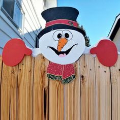 a wooden fence with a snowman on it