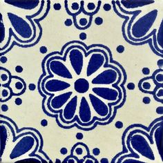 a blue and white tile with an intricate design