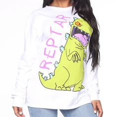 Fashion Nova Rawr Reptar Tee In White Size Small. Graphic Long Sleeved Tee With A Boyfriend Fit. 19” Underarm To Underarm, 30” Long From Neckline To Bottom At Center Of Back. All Measurements Are Approximate And Taken Laid Flat. Bundle With Other Items In My Closet And Save! Tote #3 Spring Funny Print Long Sleeve Tops, Spring Long Sleeve Tops With Funny Print, Trendy White Cartoon Print Top, Trendy White Tops With Cartoon Print, Trendy White Top With Cartoon Print, Trendy White Long Sleeve T-shirt, Stretch Crew Neck Top With Cartoon Print, White Cartoon Print Tops For Spring, Spring White Cartoon Print Tops