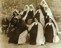 old black and white photograph of women dressed in nun costumes