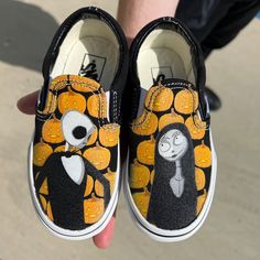 These Black Slip On Vans are inspired by the fan-favorite film, Nightmare Before Christmas. The Pumpkin King is on one shoe happily smiling at Sally on the other shoe with glowing jack-o'-lanterns in the background. We buy each pair of shoes BRAND NEW. Each pair is made to order, please make sure you put in the correct shoe size before you check out. The ink is permanent and will never come off, fade away, or peel off. Made in the USA. This price includes everything: shoes and artwork. Because t