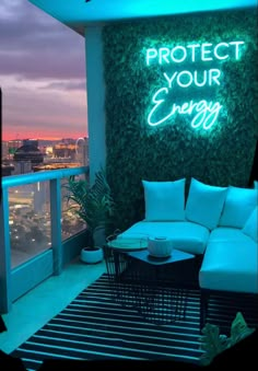 a couch sitting on top of a balcony under a neon sign