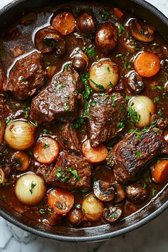 a pot filled with meat and vegetables on top of a table