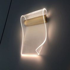 a light that is on the wall next to a roll of paper and some scissors