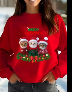 This adorable sweatshirt features funny cats dressed in Christmas sweaters and hats, perfect for the holiday festivities. It gives off a cozy and festive vibe, making it a great addition to anyone's winter wardrobe. Ideal for cat lovers and those who enjoy quirky holiday apparel. Product features - Knit in one piece without side seams for reduced fabric waste - Ribbed knit collar with seam for elasticity and shape retention - Made with a cozy medium-heavy fabric blend of 50% cotton and 50% polyester - Classic fit with crew neckline for a comfy wearing experience - Double-needle stitching for added durability Care instructions - Machine wash: cold (max 30C or 90F) - Non-chlorine: bleach as needed - Tumble dry: low heat - Do not iron - Do not dryclean Winter Cat Print Crew Neck Sweater, Winter Sweater With Cat Design, Winter Long Sleeve Tops With Cat Print, Long Sleeve Cat Print Top For Winter, Long Sleeve Tops With Cat Print For Winter, Winter Crew Neck Top With Cat Print, Red Cartoon Print Tops For Winter, Casual Christmas Sweatshirt With Cartoon Print, Cats In Sweaters