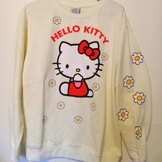 a hello kitty sweatshirt hanging on a wall