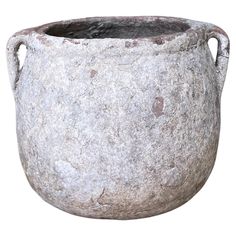 an old stone pot with handles is shown on a white background for use as a planter