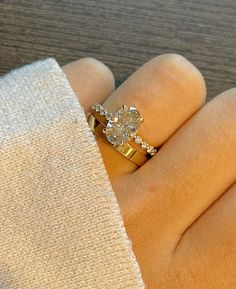 a close up of a person's hand with a ring on top of it