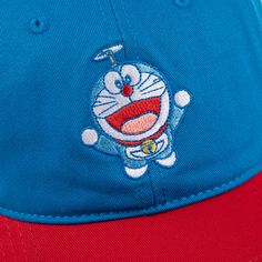 Embroidered logo art on front 6 panel design Adjustable strap-back 100% cotton Imported Officially licensed Doraemon merchandise Cotton Curved Bill Hat For Fan Merchandise, Cotton Snapback Baseball Cap For Fans, Curved Bill Cotton Hat For Fan Merchandise, Cotton Cap For Fan Merchandise, Cotton Fan Merchandise Cap, Cotton Baseball Cap For Fans During Baseball Season, Novelty Cotton Baseball Cap, Novelty Cotton Snapback Baseball Cap, Novelty Cotton Adjustable Baseball Cap