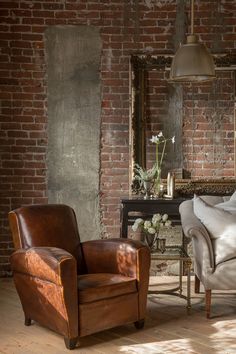 an image of a living room setting with brick walls and furniture in the background,