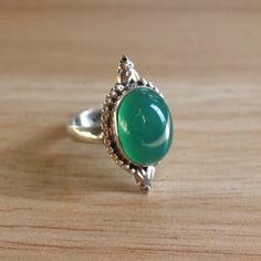 This size 9.25 beautiful green glass vintage ring is a casual but beautiful piece!  Sterling silver is hypoallergenic and safe for those with sensitive skin.  DIMENSIONS:  Band width: 3.5 millimeters Glass dimensions: 15.5 millimeters x 12.0 millimeters Weight: 6.5 grams Please note that vintage jewelry is pre-loved and might have minor imperfections as seen in the listing images. Vintage Green Turquoise Ring, Green Oval Crystal Ring In Sterling Silver, Oval Green Crystal Sterling Silver Ring, Vintage Green Crystal Ring For Anniversary, Vintage Green Emerald Open Ring, Handmade Green Oval Cabochon Ring, Classic Green Cabochon Ring, Vintage Green Open Ring Jewelry, Vintage Emerald Green Open Ring