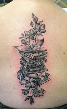 a woman's back with books and flowers on it