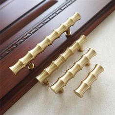 three brass handles on a wooden door