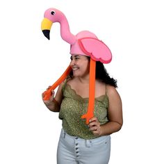 a woman wearing a pink flamingo hat and holding an orange ribbon around her neck