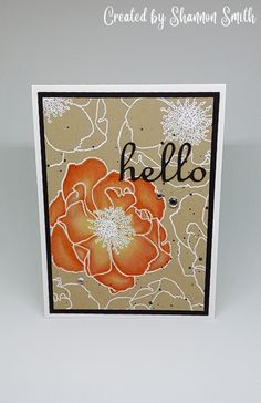 a card with an orange flower and the word hello written on it in cursive writing