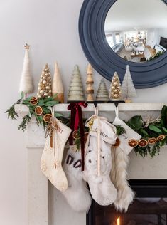 christmas stockings hanging from a mantel over a fireplace